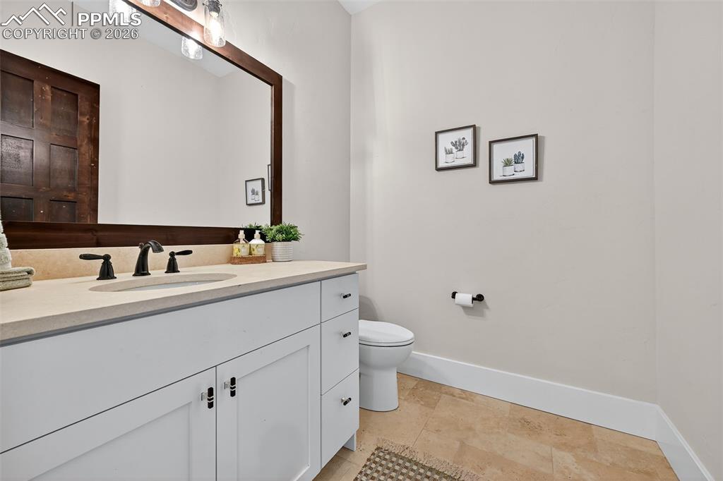 Image 37 of 49: Bathroom with vanity and baseboards