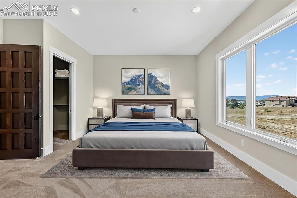 Image 40 of 49: Bedroom with a walk in closet, carpet flooring, and recessed lighting