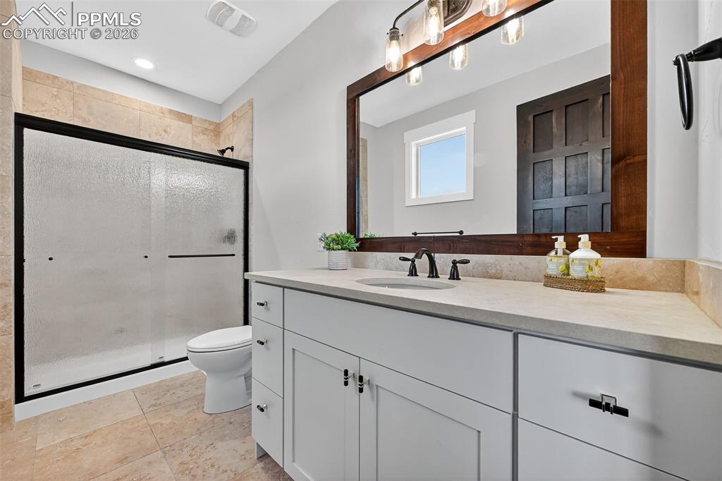 Image 41 of 49: Full bathroom featuring vanity, a stall shower, and light tile patterned fl