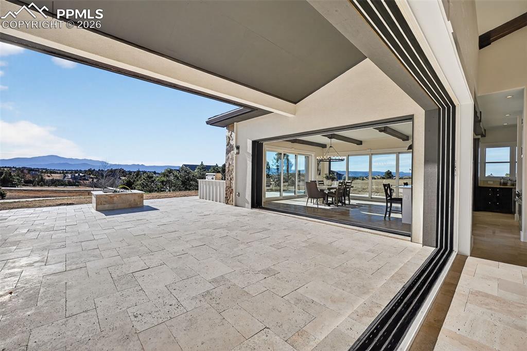 Image 49 of 49: View of patio with a mountain view and outdoor dining space