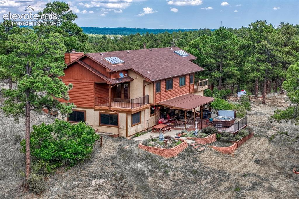 Caption: Nestled among towering trees on 5 horse-zoned acres, this one-of-a-kind property combines privacy, b
