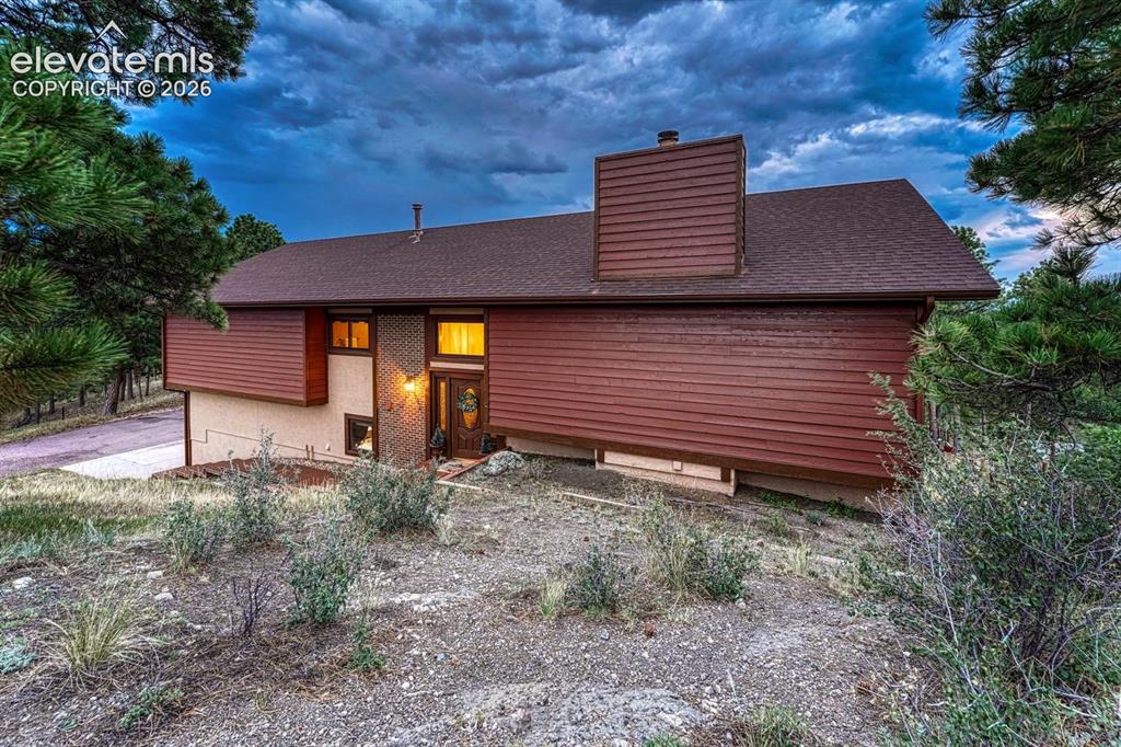 Image 10 of 50: Sunset view of the front of the home.