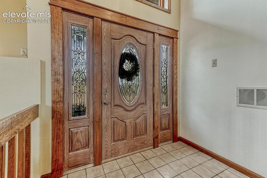 Image 11 of 50: Elegant front door with sidelites and lead glass inserts.