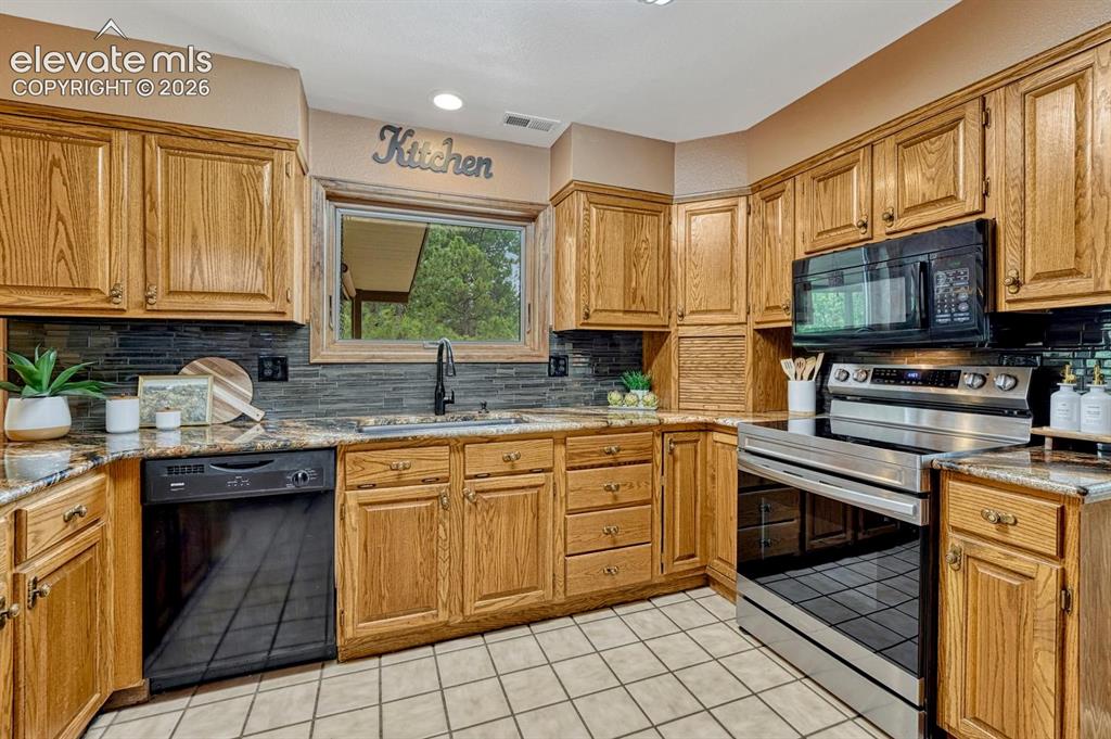 Image 20 of 50: 
Appliances include a smooth top range oven, overhead microwave, dishwasher