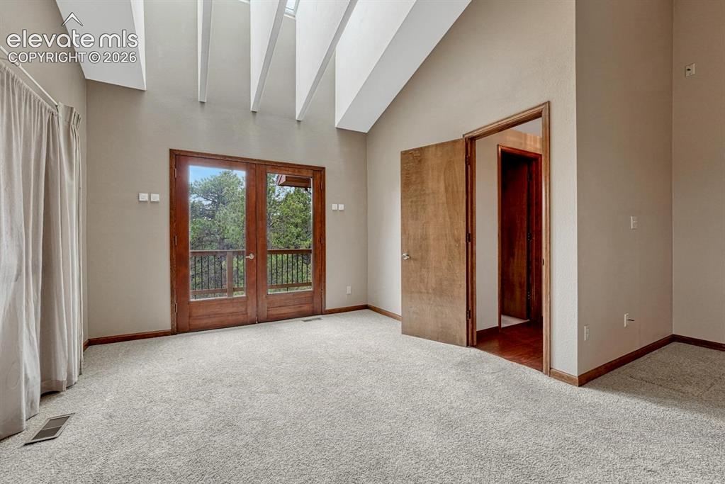 Image 32 of 50: French doors from the Primary Bedroom to a private deck.