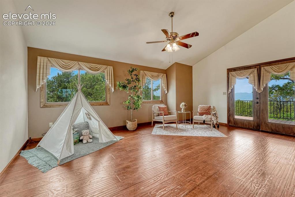 Image 6 of 50: The spacious living room features LVP flooring and French doors to a Trex d