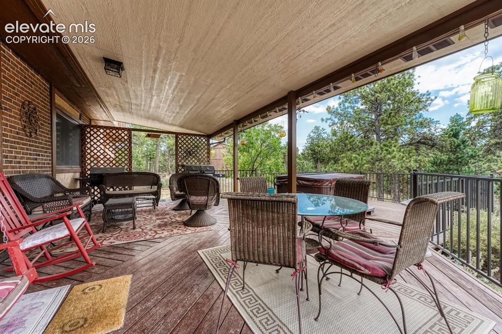 Image 8 of 50: Covered deck off the Dining Nook for outdoor dining and relaxawtion.