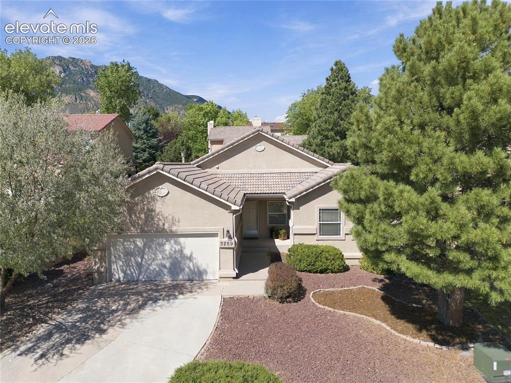 Image 1 of 24: beautiful stucco and tile roof ranch style home with driveway facing mornin