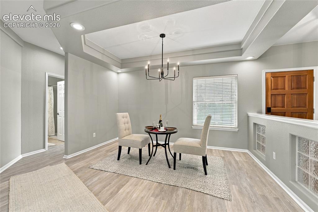 Image 10 of 25: formal dining area with ceiling accents and new chandelier