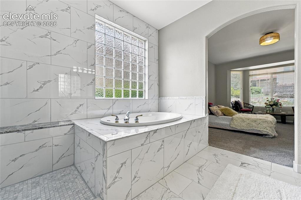 Image 11 of 25: primary suite adjoining luxury ensuite with new tile throughout