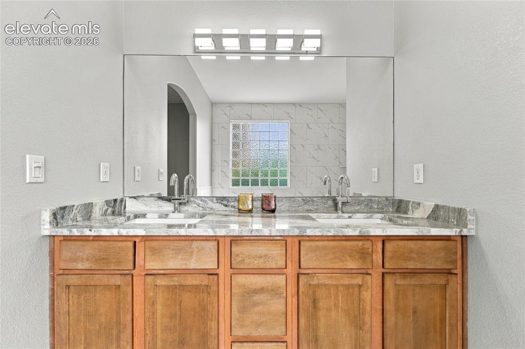 Image 12 of 24: new high end granite, light fixture and bath hardware