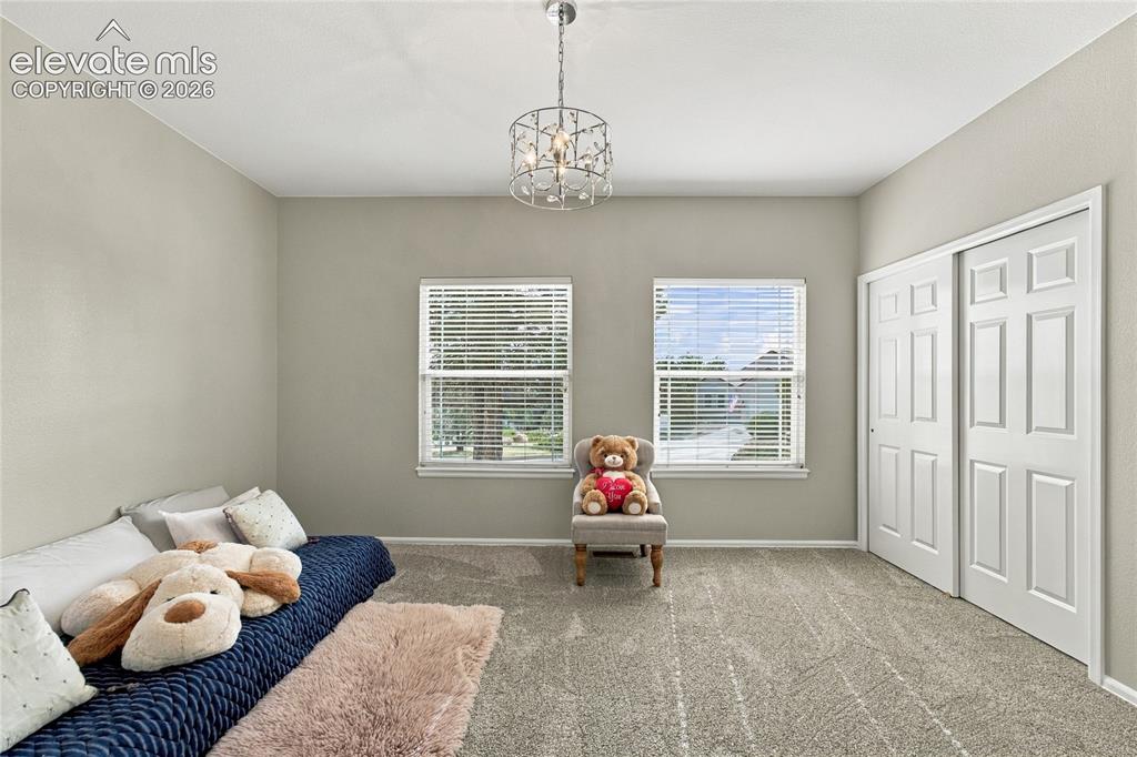 Image 13 of 24: large main level second bedroom with dual closets and new light fixture