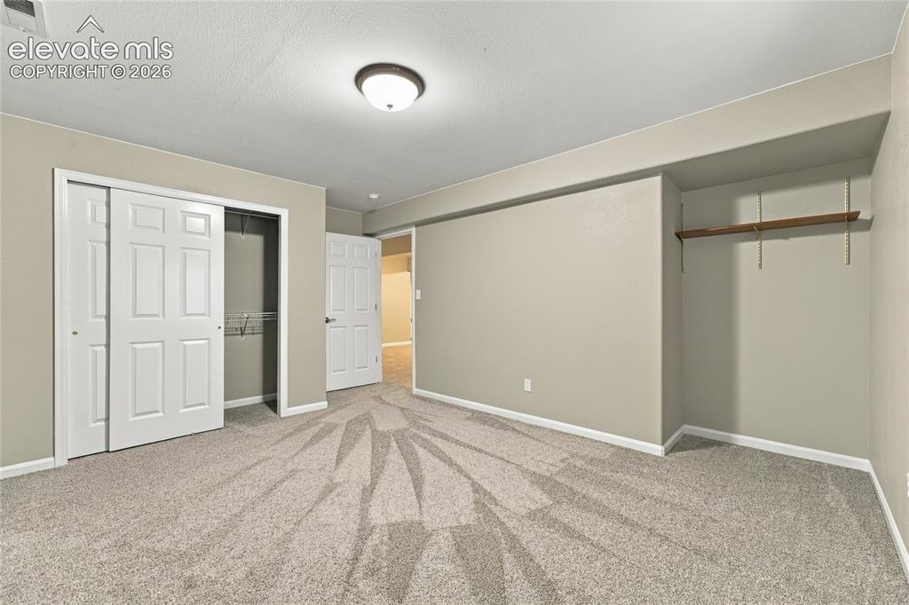 Image 22 of 25: another basement bedroom
