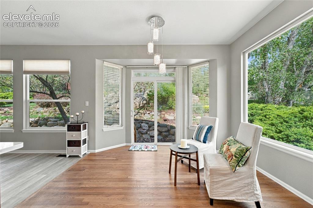 Image 7 of 25: kitchen nook with bright light and access to back yard