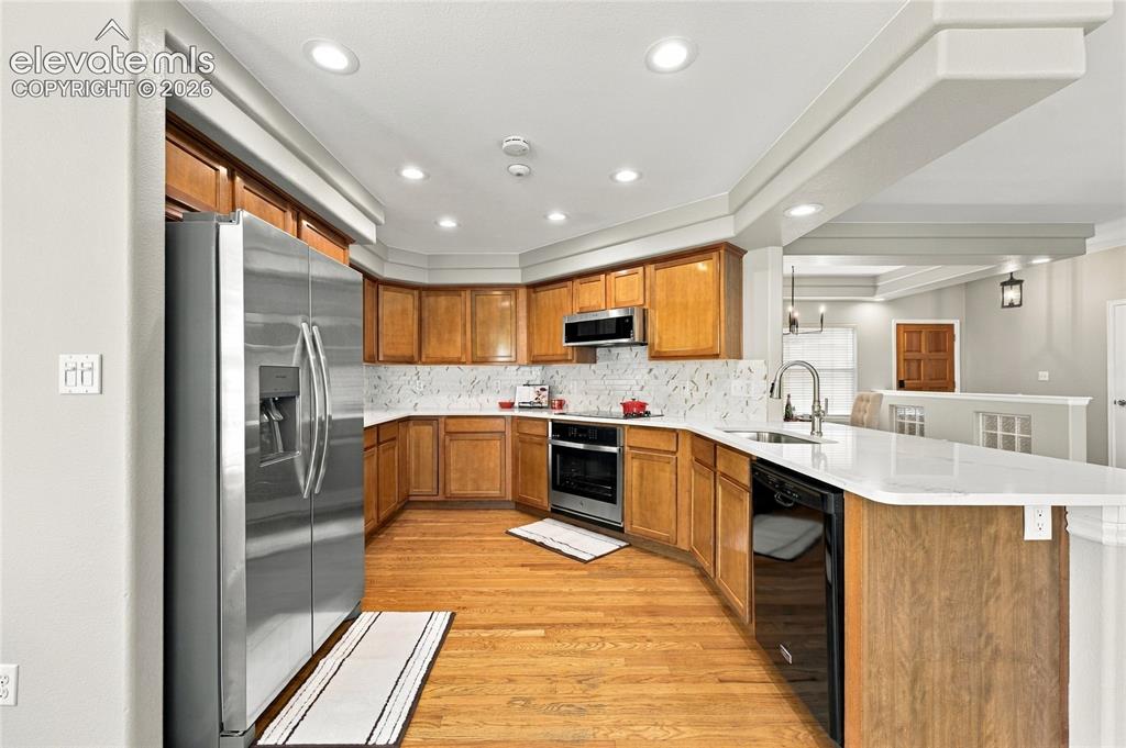 Image 8 of 25: spacious kitchen with new counter tops and new backsplach