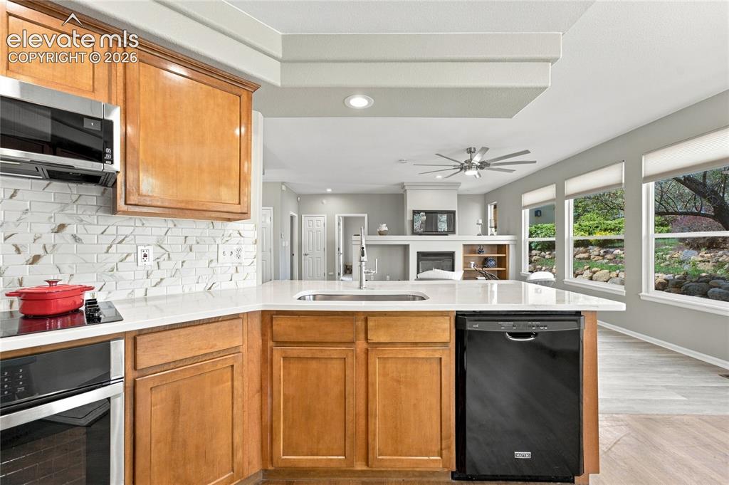 Image 9 of 25: open concept kitchen adjoining kitchen nook and overlooking the living room