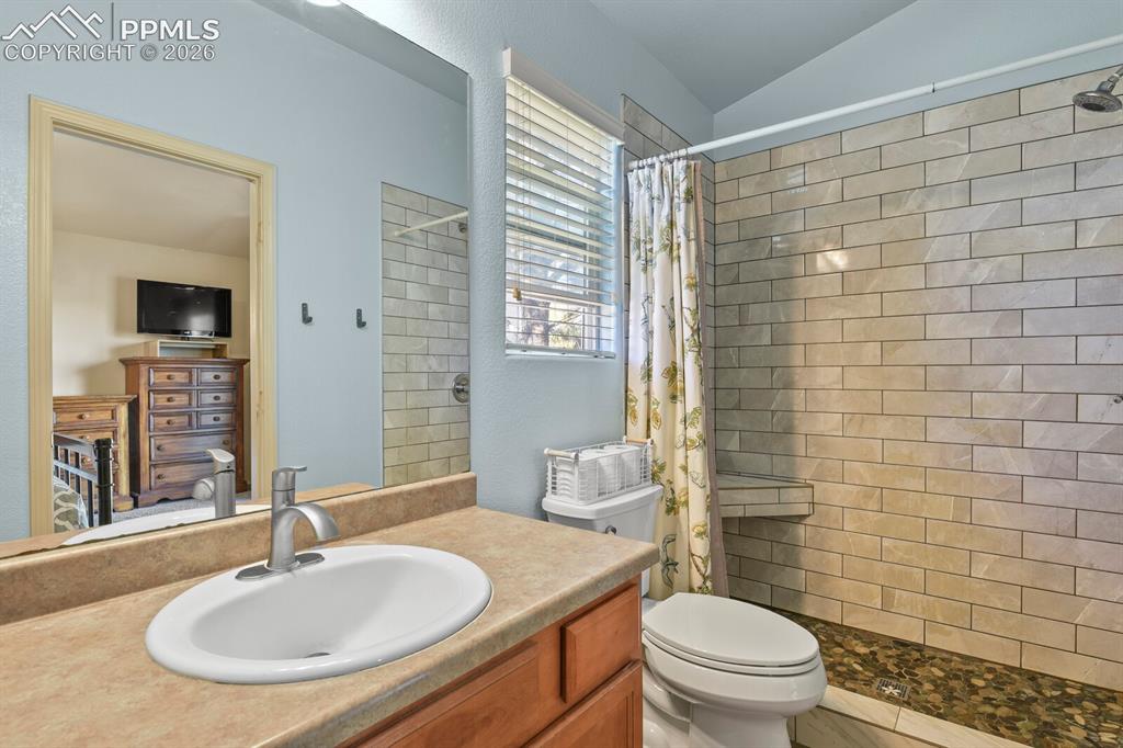 Image 15 of 21: Walk-in shower with updated tile .
