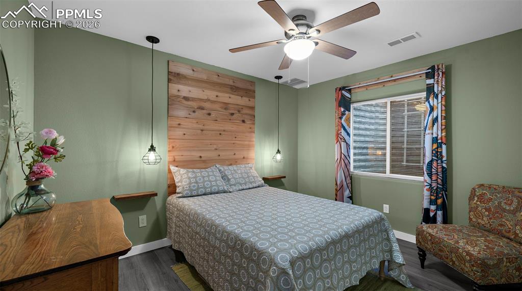 Image 28 of 43: Bedroom with dark wood-type flooring and ceiling fan