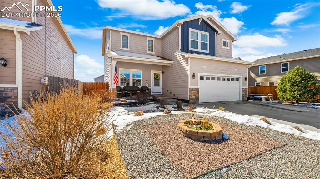 Image 3 of 43: Craftsman-style home with an attached garage, stone siding, board and batte