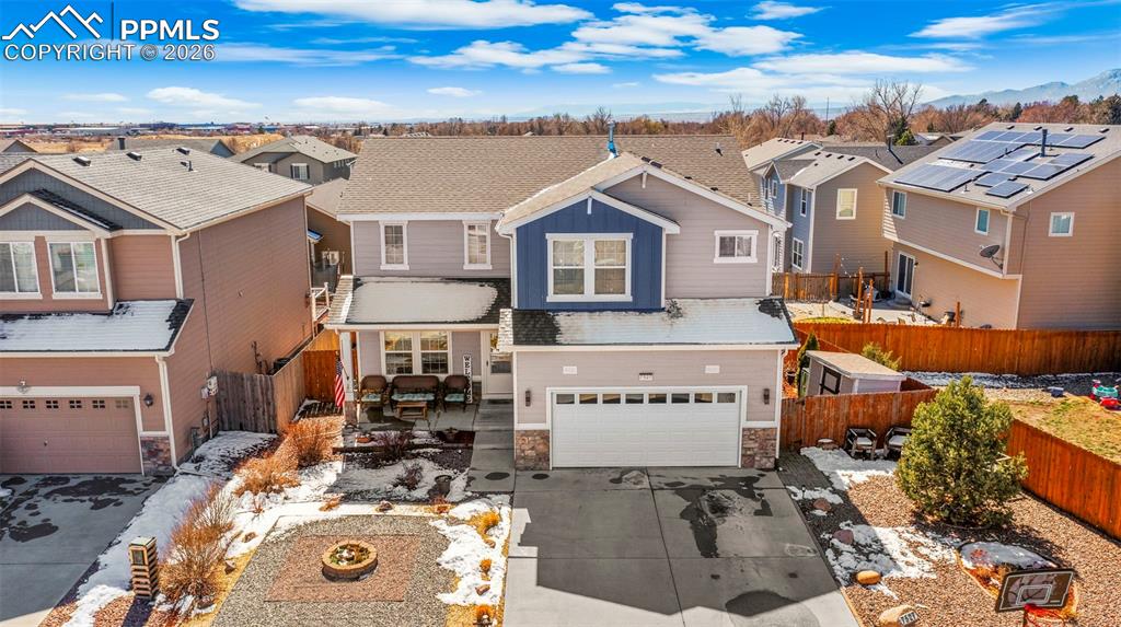 Image 30 of 43: View of front facade featuring a residential view, stone siding, an attache
