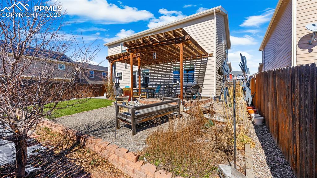 Image 33 of 43: Rear view of house featuring a pergola, a patio area, and a fenced backyard