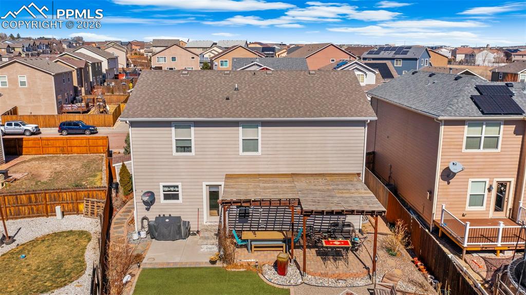 Image 37 of 43: Back of house with a patio, a fenced backyard, a residential view, and roof
