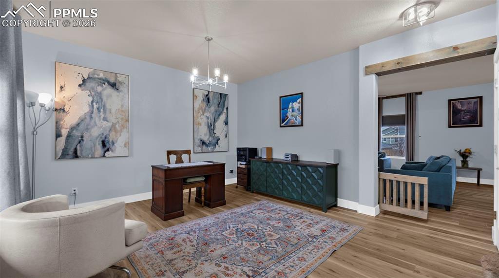 Image 4 of 43: Dining space with light wood-style flooring, suspended lighting, and an off