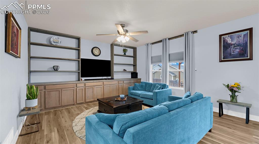 Image 6 of 43: Living room featuring ceiling fan and light wood-style flooring