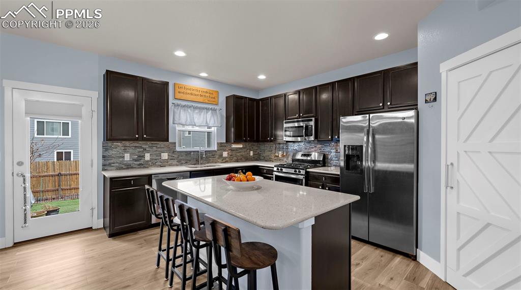 Image 9 of 43: Kitchen featuring dark wood finish cabinetry, stainless steel appliances, a