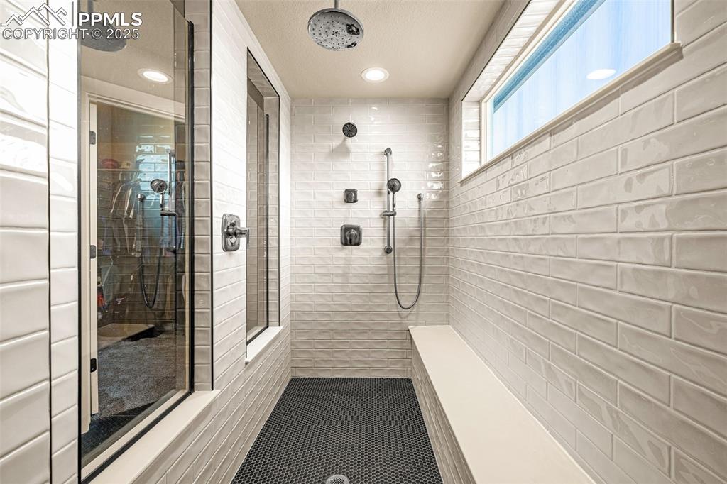 Image 10 of 46: Full bathroom with tiled shower and recessed lighting
