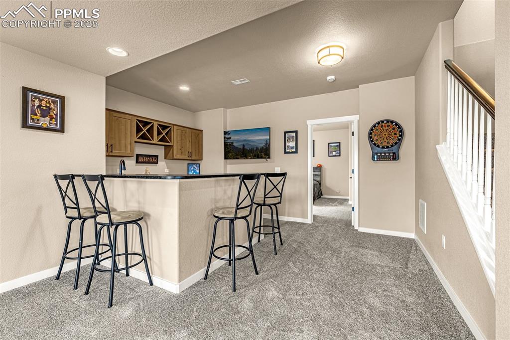 Image 11 of 46: Bar w/ Leathered Granite Countertop
