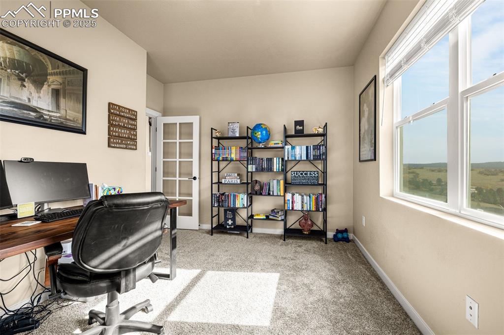 Image 14 of 46: Office area featuring light colored carpet and baseboards
