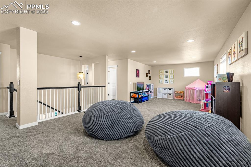 Image 23 of 46: Recreation room with carpet flooring, recessed lighting, and a textured cei