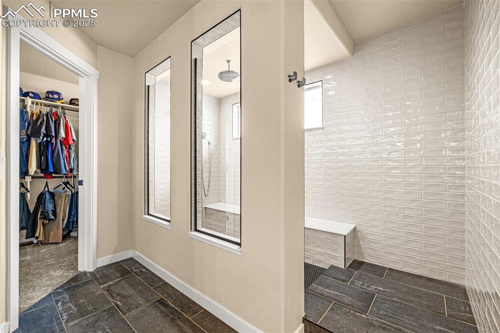 Image 27 of 46: Full bathroom featuring a walk in closet and a walk in shower