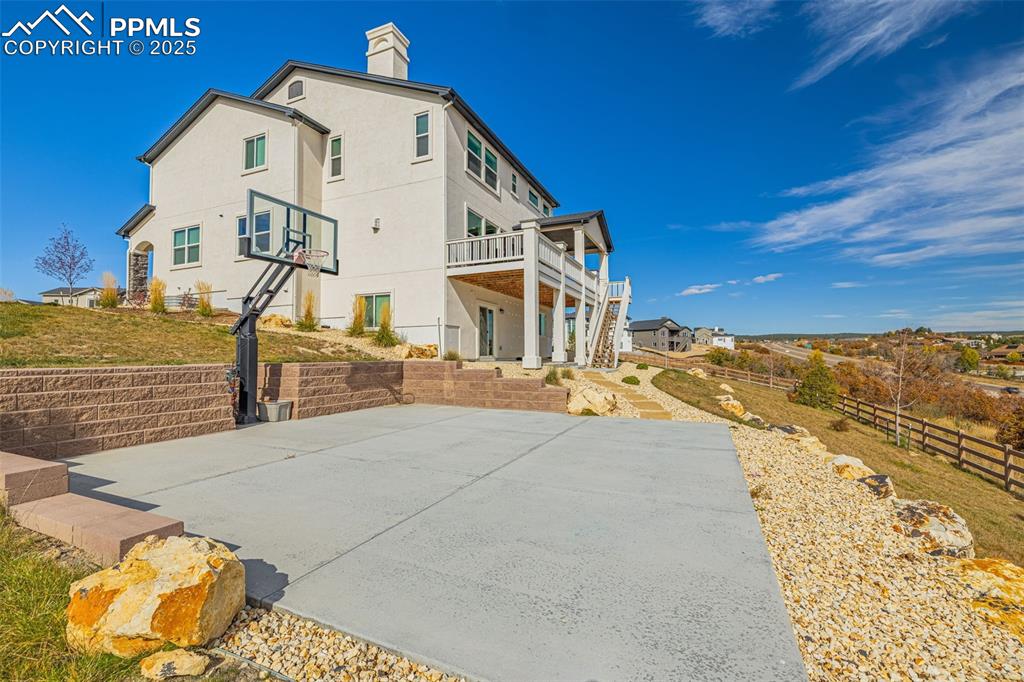 Image 3 of 46: View of basketball court featuring a patio area and stairs