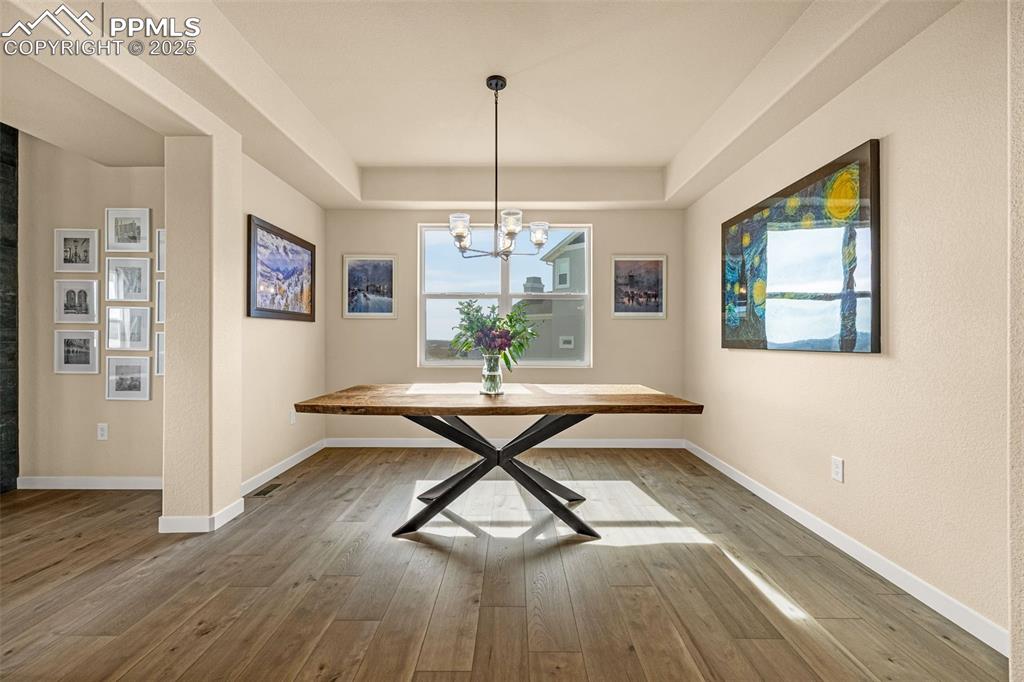 Image 8 of 46: Unfurnished dining area featuring light wood-style floors and a chandelier