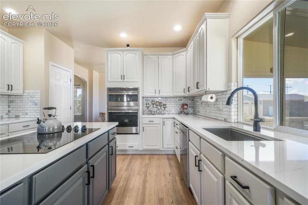 Image 10 of 50: Beautiful Backsplash with Large Farmhouse Sink.
