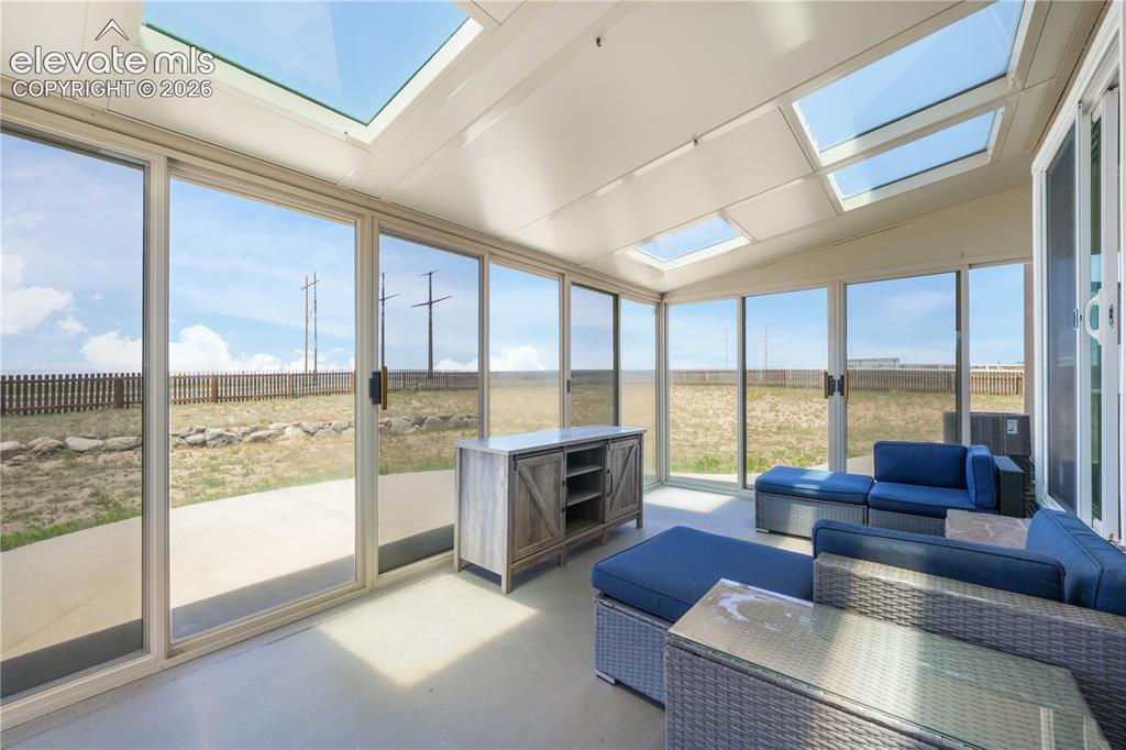 Image 13 of 50: Enclosed Sunroom with Skylights
