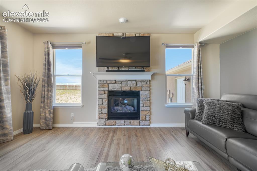 Image 15 of 50: Spacious Family Room with Gas Fireplace and Natural Light