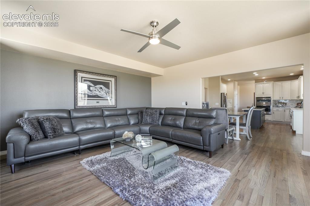 Image 16 of 50: Spacious Family Room with Gas Fireplace and Natural Light