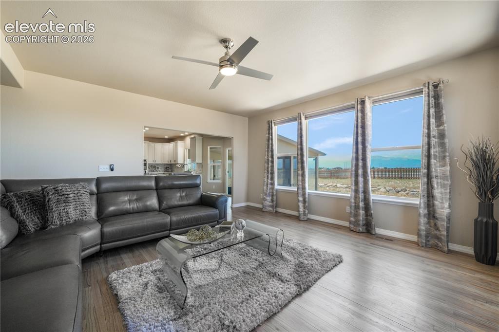 Image 17 of 50: Spacious Family Room with Gas Fireplace and Natural Light