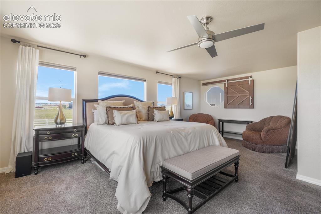 Image 25 of 50: Spacious Primary Bedroom with Sitting Area