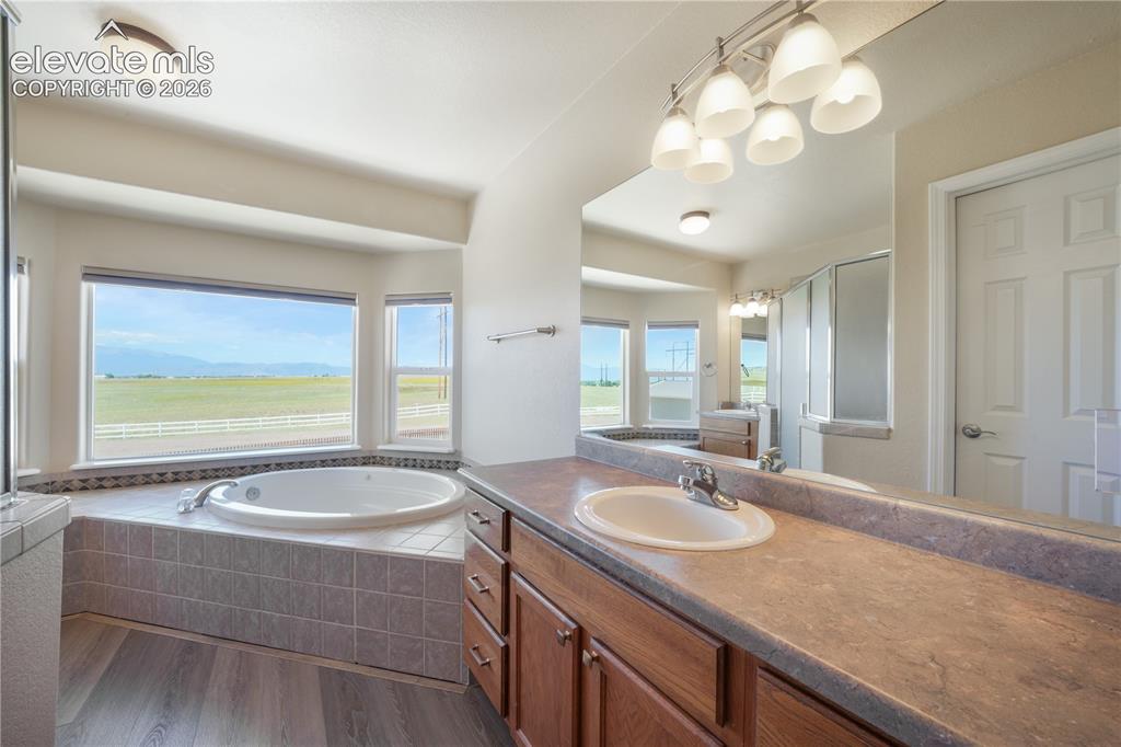 Image 27 of 50: Separated Vanities, Jetted Tub and Stand Alone Shower