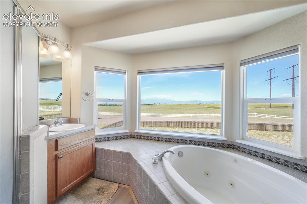 Image 28 of 50: Separated Vanities, Jetted Tub and Stand Alone Shower