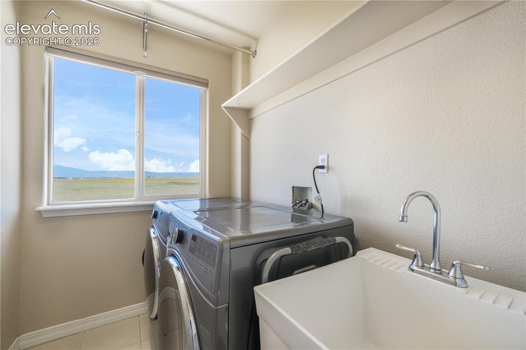 Image 29 of 50: Upper Level Laundry Room with Utility Sink & Window