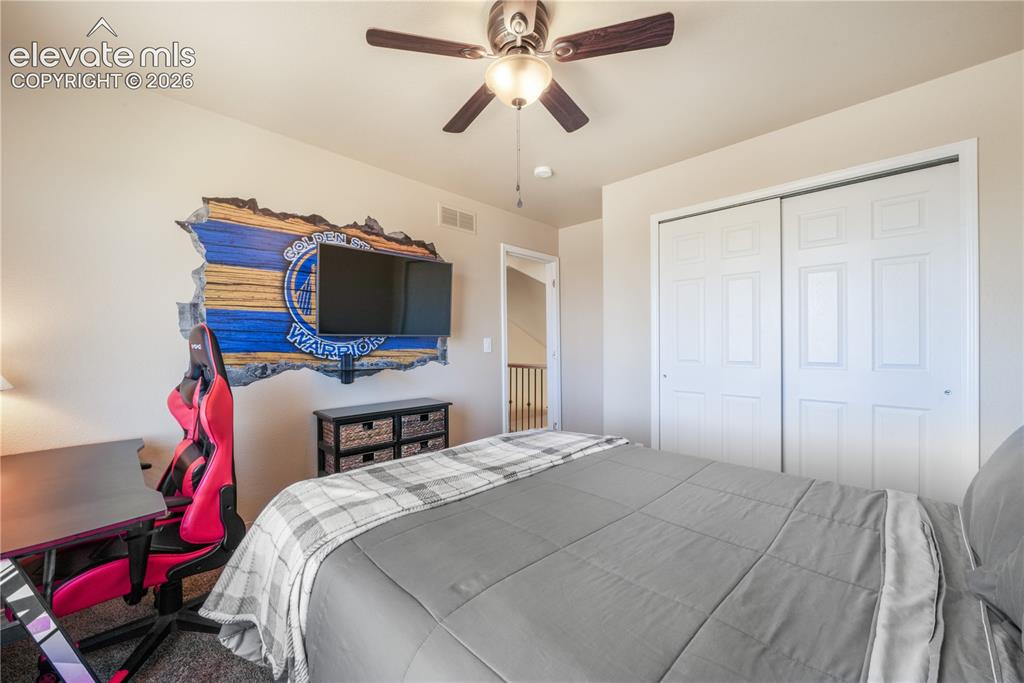 Image 32 of 50: Upper Level Bedroom with Ceiling Fan and View.