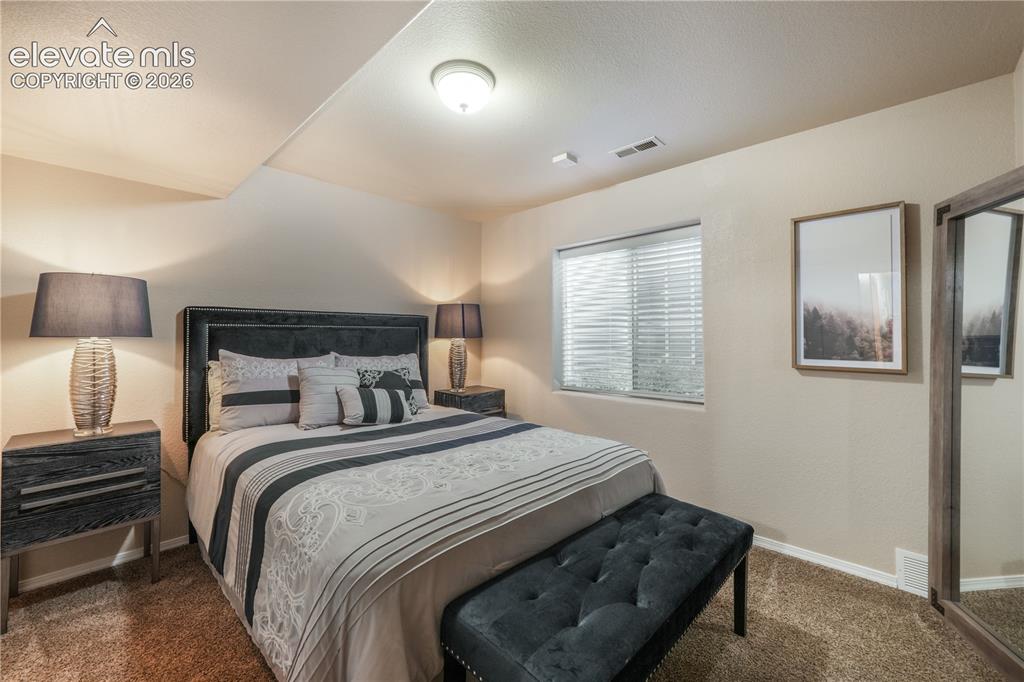 Image 40 of 50: Basement Bedroom with Barn Door connecting to Second Basement Bedroom