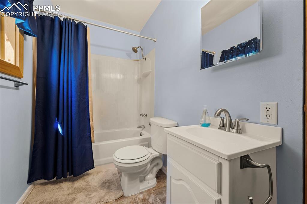 Image 15 of 27: Bathroom featuring shower / tub combo and vanity
