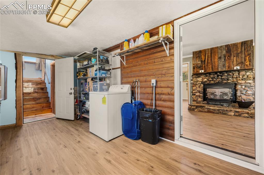 Image 18 of 27: Basement with washer / dryer, wood finished floors, and stairs