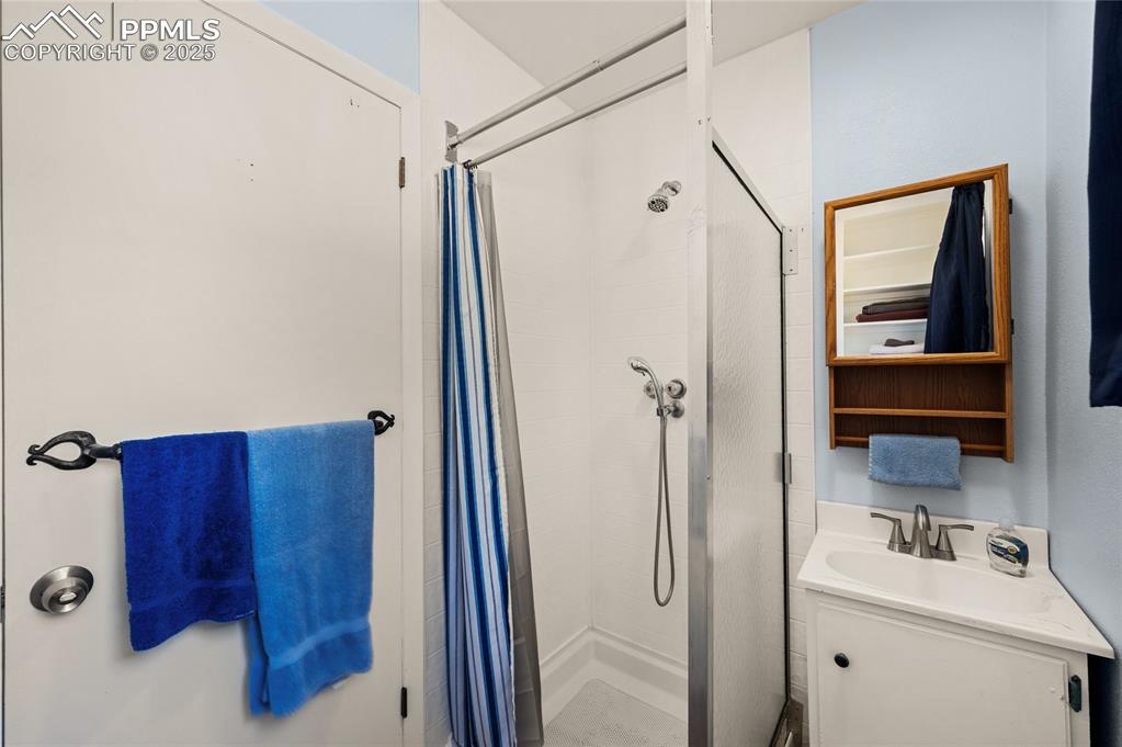 Image 22 of 27: Full bath with a stall shower and vanity